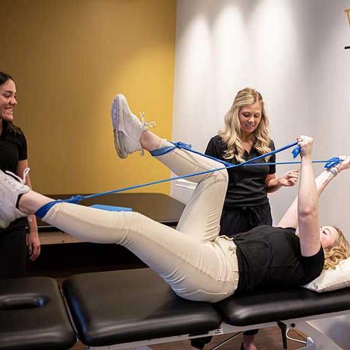 Students practice physical therapy using bands
